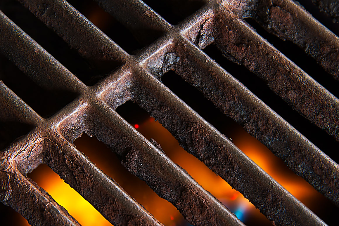 a close up of a grill with a rusty grate