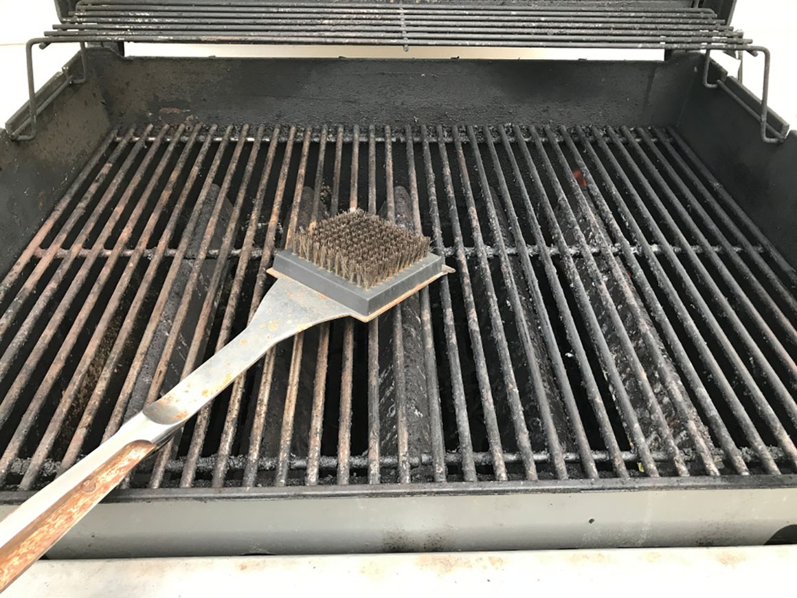 a metal barbecue brush on a grill