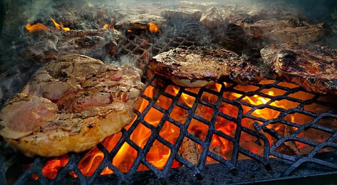chicken being cooked on a grill