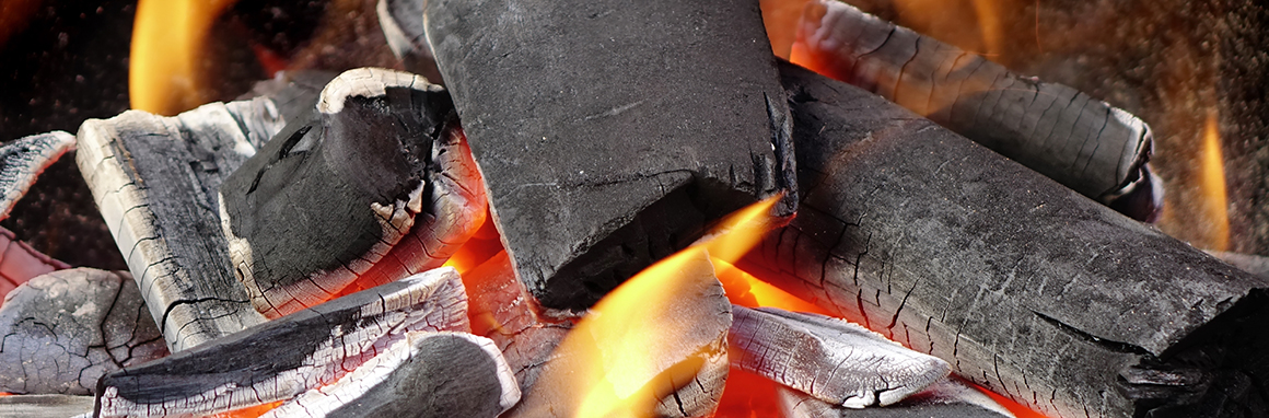 a close up of burning charred wood