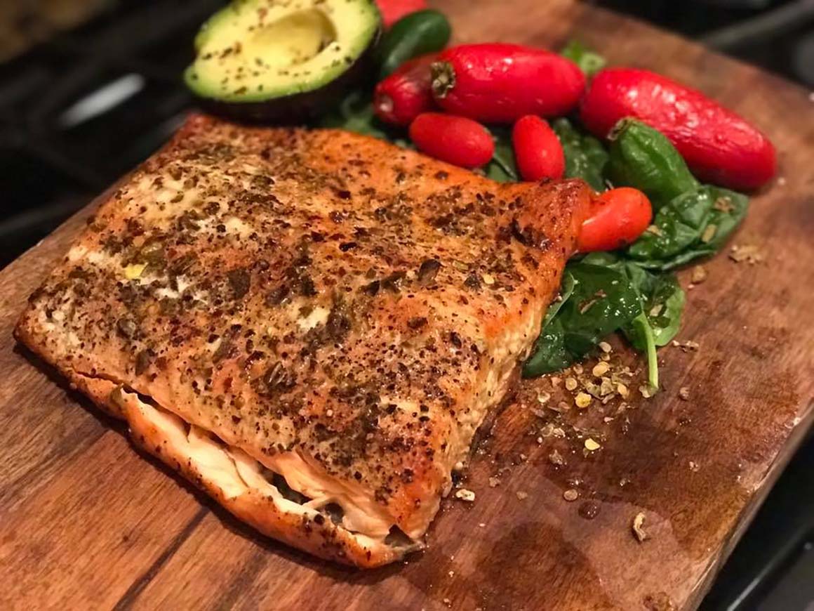 grilled salmon and veggies on cutting board