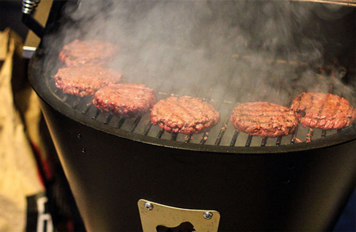 burger patties frying on grill