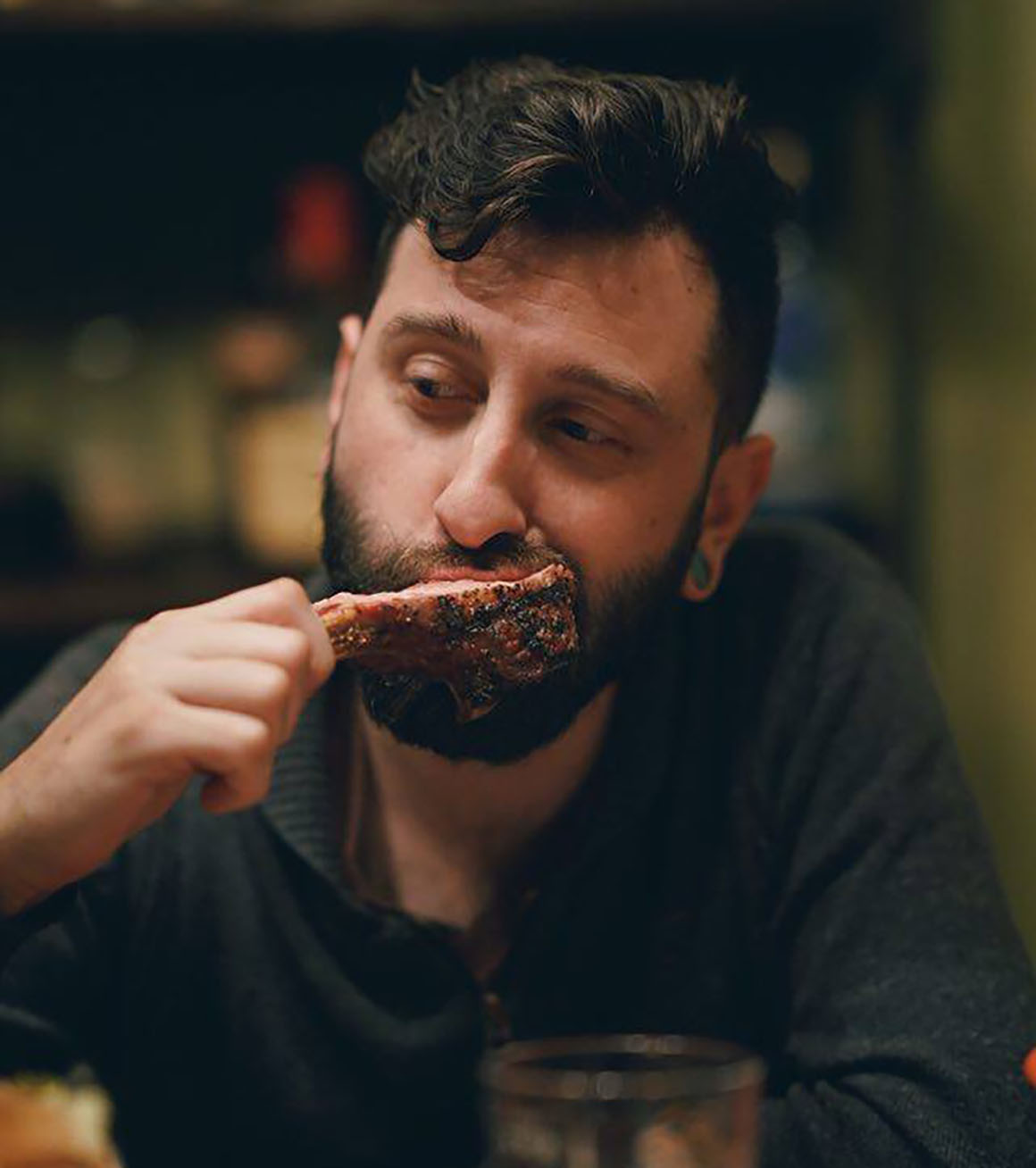 man eating grilled rib