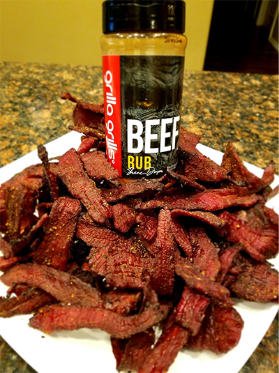 a bottle of grilla grills beef rub on a plate of bacon