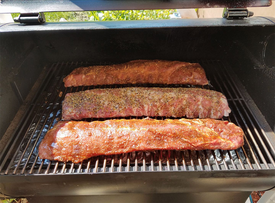 a few racks of ribs on a grill